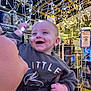baby, child, smiling, lights, string_lights, dimples, sweater, person, hand, store, holiday, festive, decoration, indoor, happy, face, holding, adult, cheerful, shopping
