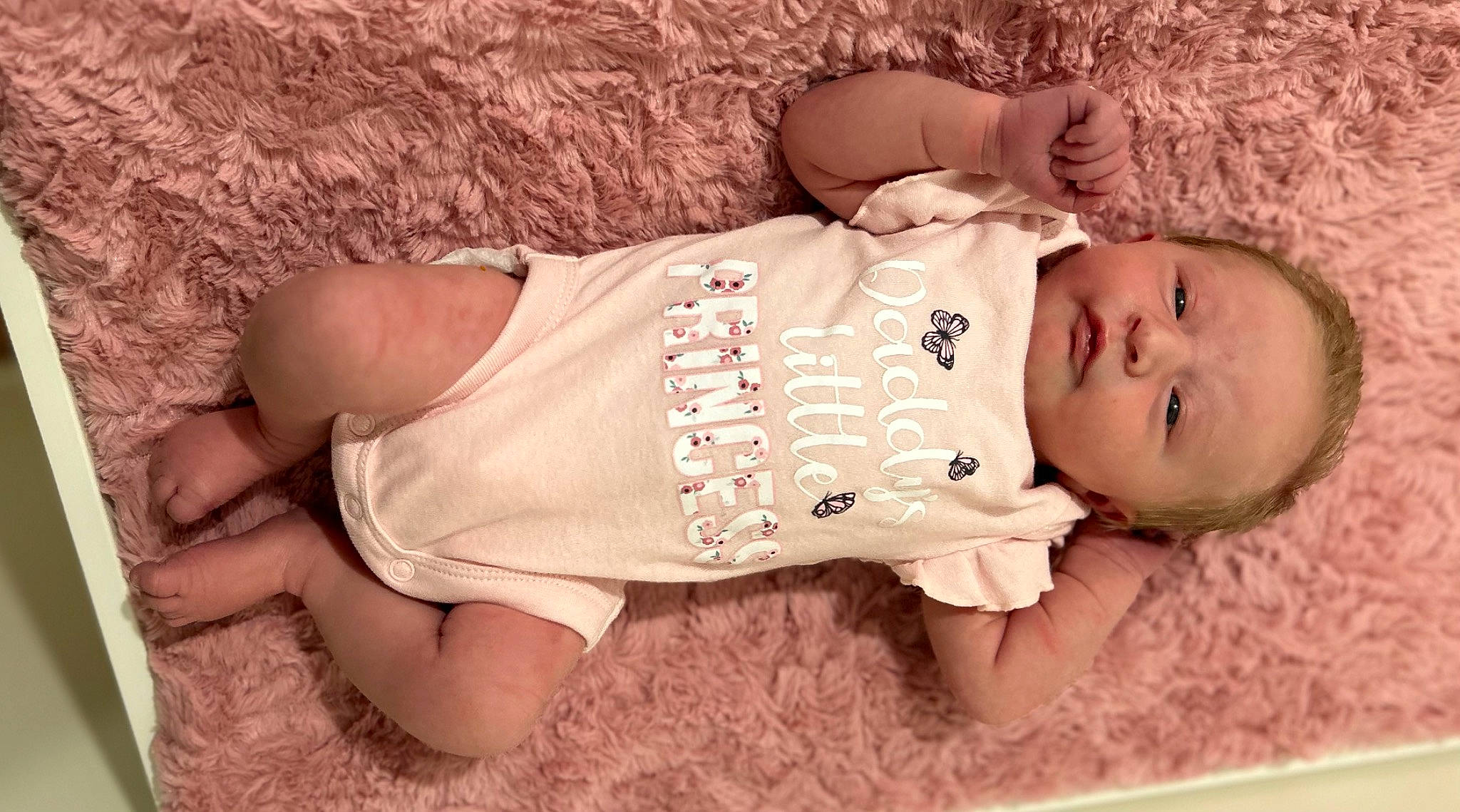 Lilliana is registered to the contest to win money with this photo: arm, baby, baby_toddler_clothing, child, dress, finger, grass, happy, human_body, lip, neck, nose, person, pink, skin, sleeve, textile, thigh, toddler, trunk