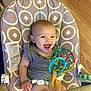 Khaleesi joined the competition — help win amazing prizes! baby, smiling, child, toy, bouncer, colorful, indoor, happy, infant, floor, wooden_floor, seat, play, pattern, striped_clothing, person, cute, expression, hand, face