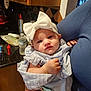 Khaleesi joined the competition — help win amazing prizes! baby, child, headband, bow, pacifier, kitchen, person, arm, clothing, water_bottle, counter, cabinet, furniture, indoor, expression, holding, cute, infant, portrait, young