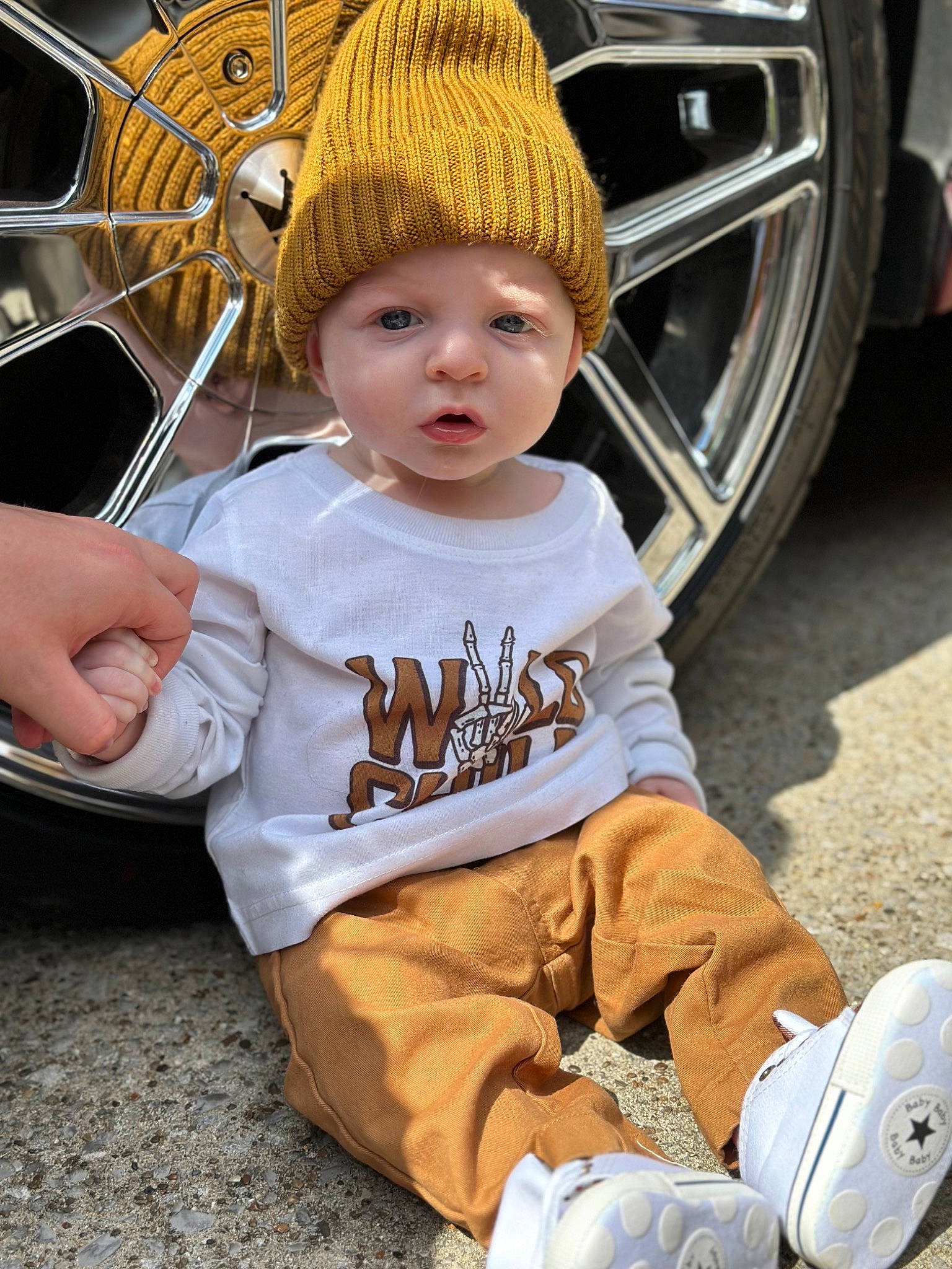 Karsyn Pryor joined the competition — help win amazing prizes! automotive_tire, automotive_wheel_system, cap, child, costume_hat, fashion_accessory, fun, grass, happy, hat, headgear, headwear, leg, person, plant, sitting, sneakers, tire, toddler, tree