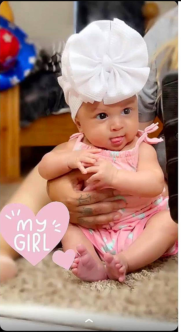 Alaya is registered to the contest to win money with this photo: baby, baby_toddler_clothing, balloon, cap, child, event, fashion_accessory, finger, fun, gesture, happy, headwear, nail, party_supply, peach, person, photograph, pink, sitting, skin
