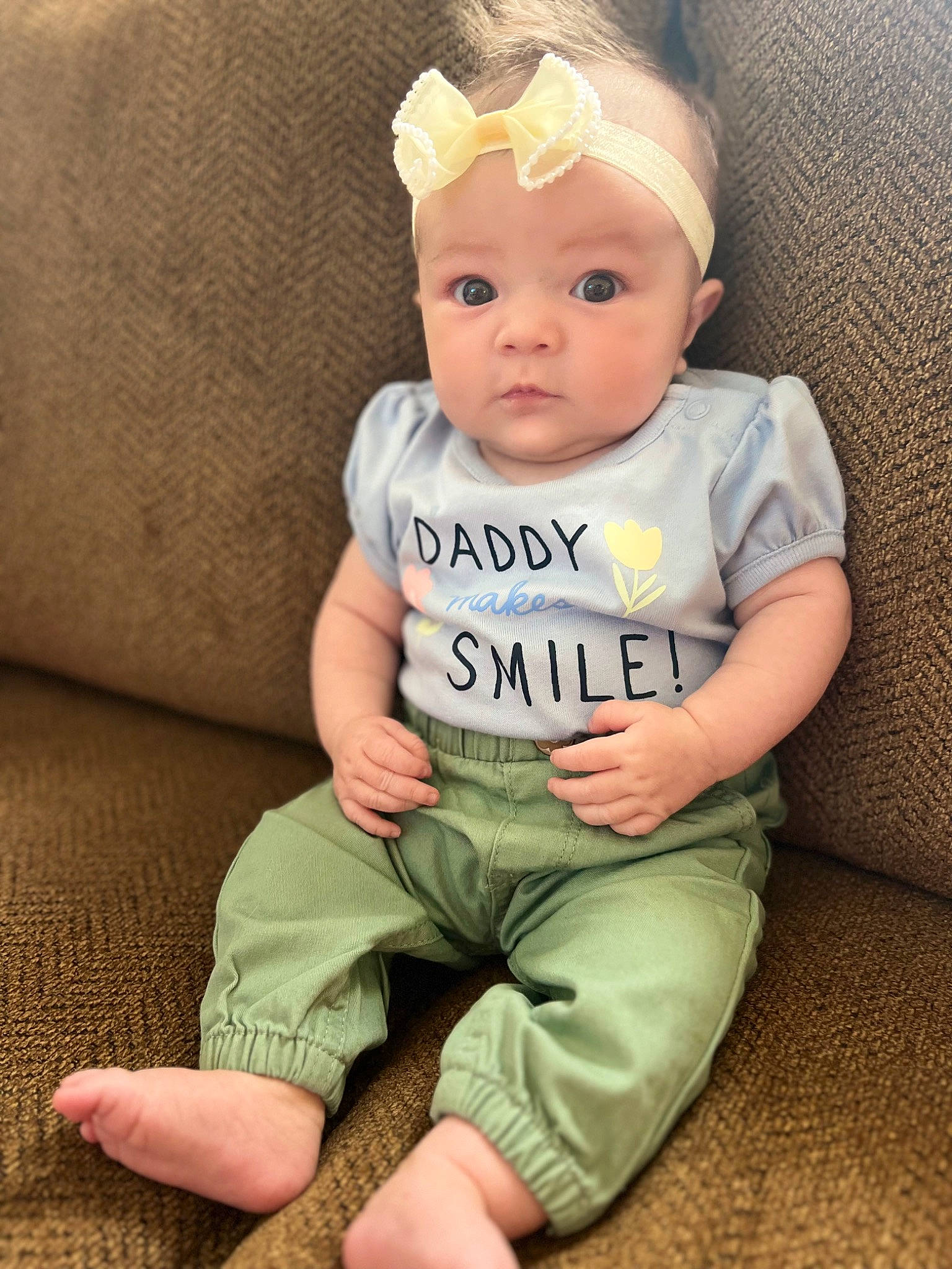 April is registered to the contest to win money with this photo: baby, baby_toddler_clothing, cap, cheek, child, chin, comfort, costume_hat, fashion_accessory, finger, happy, head, headband, human_body, neck, person, sitting, skin, sleeve, t_shirt