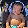 Aziel is registered to the contest to win money with this photo: baby, child, car_seat, hat, toy, smile, sunlight, cute, infant, sitting, happy, skin, hand, foot, curly_hair, summer, outdoor, playful, relaxed, portrait