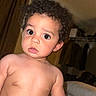 Aziel joined the competition — help win amazing prizes! toddler, child, baby, curly_hair, indoor, bed, blanket, diaper, expression, wide_eyes, person, skin, hair, curtains, clothing, room, furniture, portrait, sitting, young_child