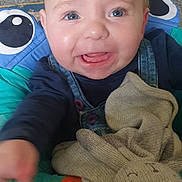 Lennie-Bluu is registered to the contest to win money with this photo: baby, child, smiling, blue_eyes, knitted_toy, bunny, baby_seat, colorful, carpet, clothing, denim, happy, indoor, cute, infant, toy, portrait, reaching, playful, toddler