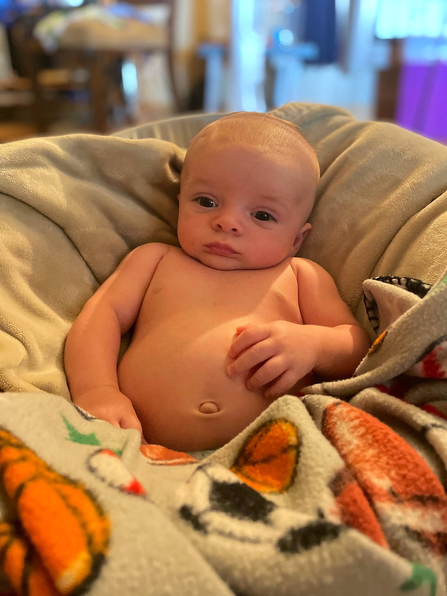 Mason is registered to the contest to win money with this photo: abdomen, baby, baby_products, cheek, child, comfort, finger, fun, happy, iris, linens, mouth, orange, people, person, room, sitting, skin, toddler, toy