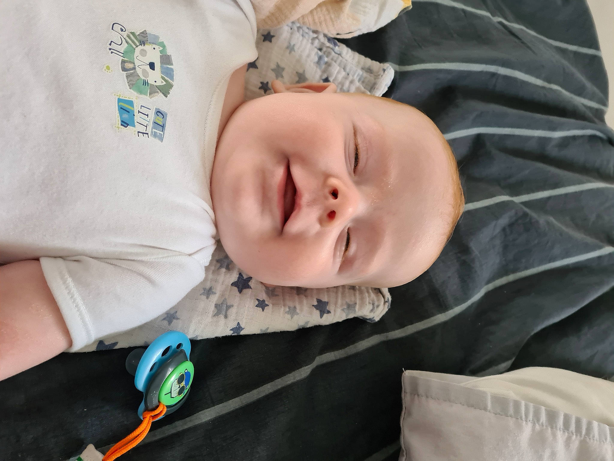 Sebastian is registered to the contest to win money with this photo: baby, baby_products, baby_toddler_clothing, child, comfort, eye, happy, linens, pattern, person, portrait_photography, sleep, sleeve, smile, t_shirt, textile, toddler