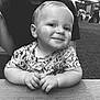 baby, child, smile, face, hands, table, wood, outdoor, grass, person, clothing, portrait, black_and_white, happy, cute, sitting, young_child, short_hair, toddler, casual