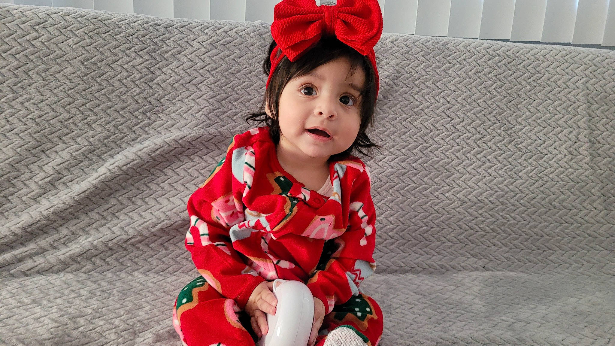 Vivian is registered to the contest to win money with this photo: baby, baby_toddler_clothing, cap, carmine, collar, comfort, costume_hat, couch, face, fashion_accessory, fun, happy, headgear, pattern, person, plaid, red, sleeve, smile, textile