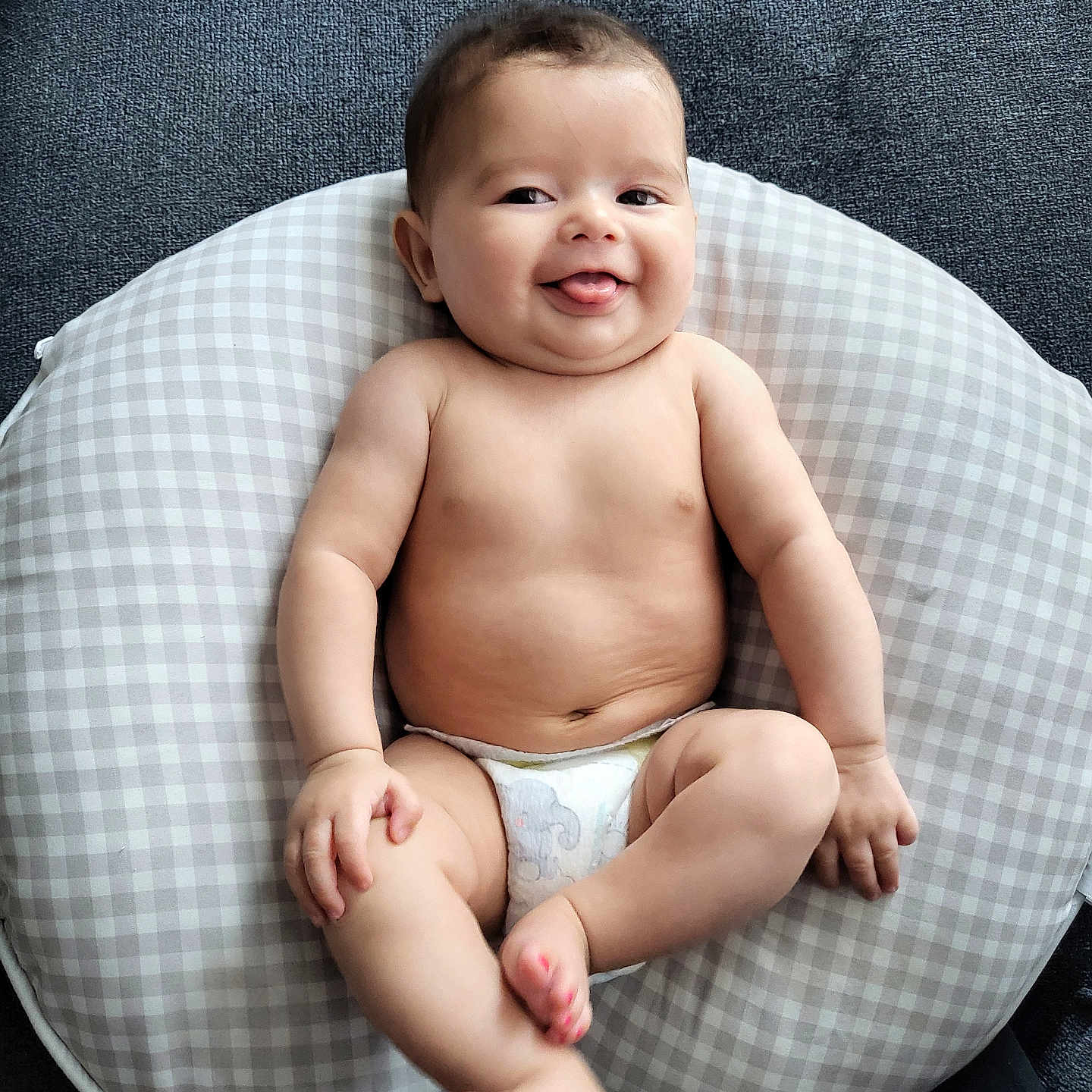 Ivy is registered to the contest to win money with this photo: baby, babylaughing, bodypart, clothing, couch, cushion, diaper, face, finger, furniture, hand, happy, head, homedecor, newborn, person, photography, portrait, sitting, smile