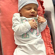 Emersyn joined the competition — help win amazing prizes! newborn, baby, sleeping, infant, hat, white_outfit, blanket, coral, soft_fabric, peaceful, closeup, indoors, portrait, cute, small_hands, resting, cozy, child, person, sleep