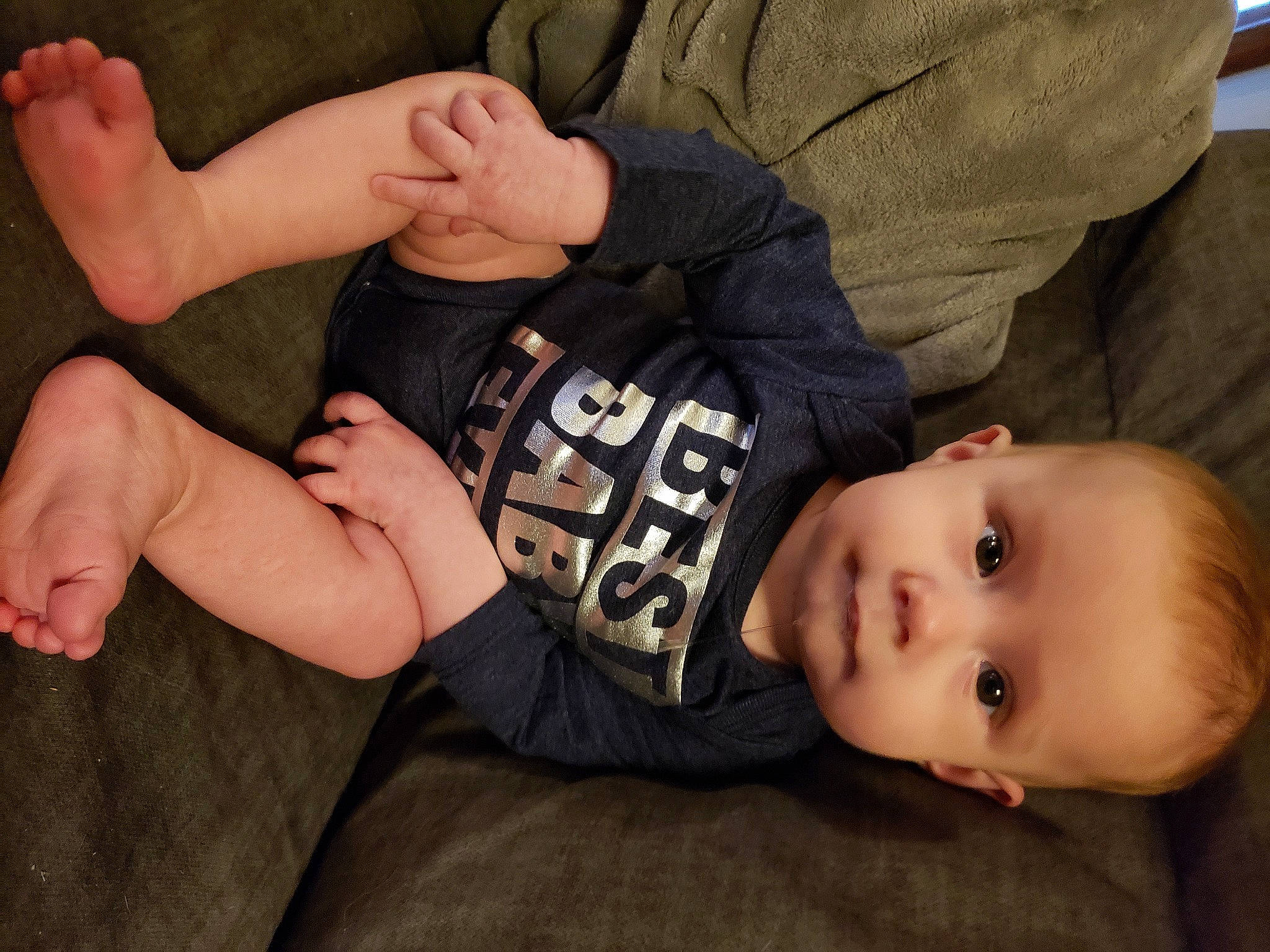 Jase is registered to the contest to win money with this photo: baby, baby_toddler_clothing, cheek, child, comfort, elbow, gesture, grass, hand, human_body, joint, nail, person, plant, sitting, skin, sleeve, thumb, toddler, wood