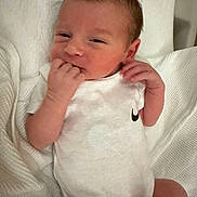 Kingston is registered to the contest to win money with this photo: baby, newborn, infant, onesie, white_clothing, blanket, hand, face, skin, sleepy, cute, small, child, person, indoors, soft, resting, lying_down, newborn_baby, cozy