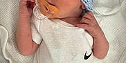 Kingston is registered to the contest to win money with this photo: baby, newborn, pacifier, hat, knitted_hat, onesie, white_clothing, sleeping, blanket, resting, infant, cute, small_hands, soft_texture, indoors, peaceful, portrait, close_up, child, baby_garment