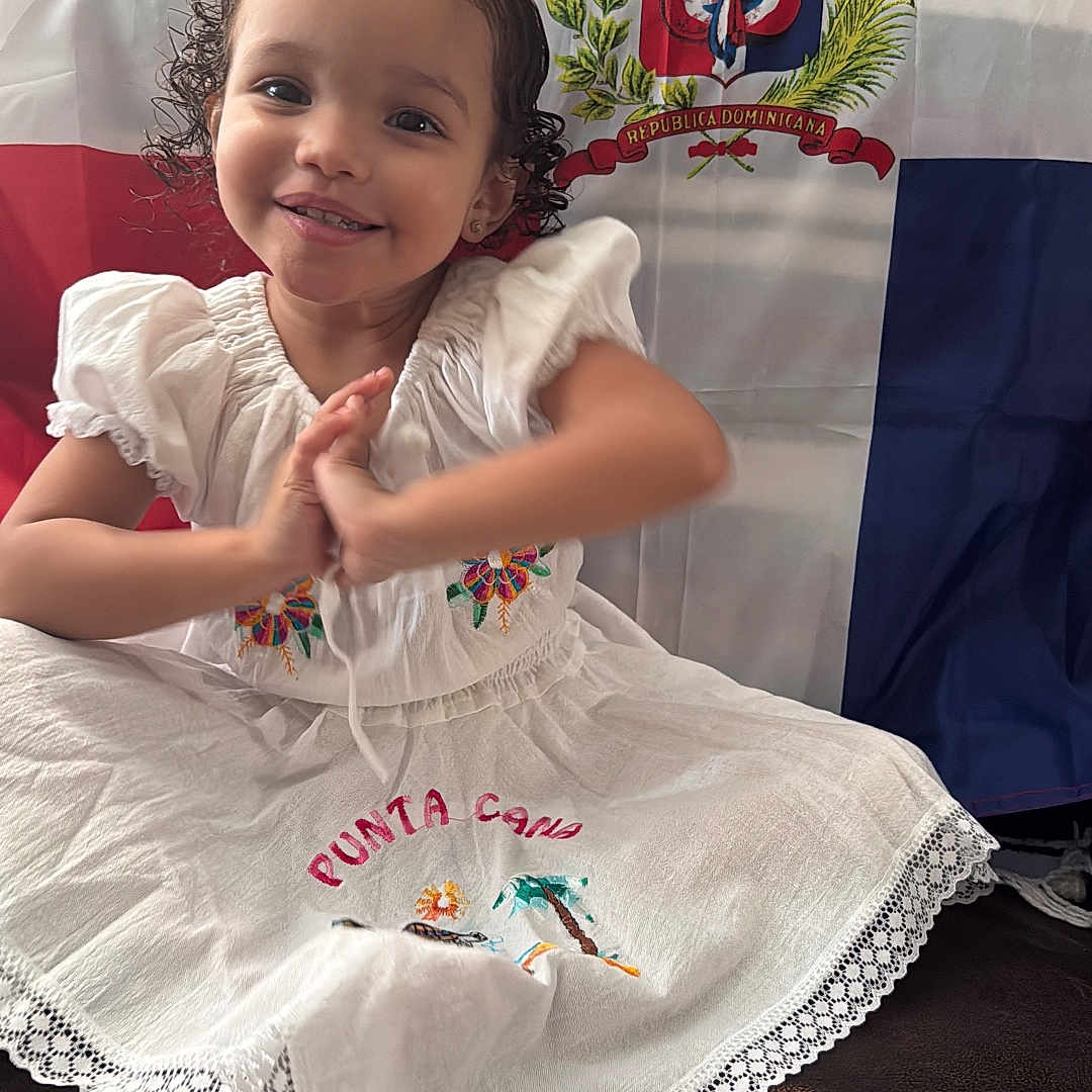 Joanny is registered to the contest to win money with this photo: applique, blouse, bodypart, child, clothing, cushion, dress, face, female, finger, flag, girl, hand, hat, head, homedecor, pattern, person, photography, portrait