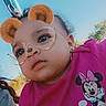 child, toddler, swing, outdoor, playground, sky, glasses_filter, bear_ears_filter, pink_shirt, minnie_mouse, cute, face, person, daylight, nature, trees, fun, expression, clothing, activity