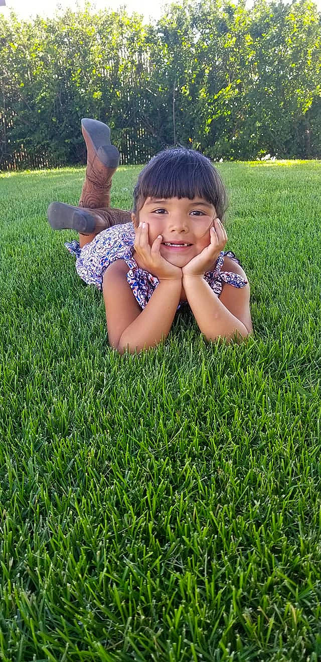 Tracy joined the competition — help win amazing prizes! artificial_turf, black_hair, child, fun, grass, grass_family, grassland, green, groundcover, happy, joy, lawn, leaf, leisure, meadow, people_in_nature, person, plant, skin, smile