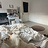 dog, bed, blanket, bedroom, mirror, vanity, floor, door, television, pet_bed, white_wall, light, furniture, relaxed, paw, sleeping, cozy, indoors, room, comfort