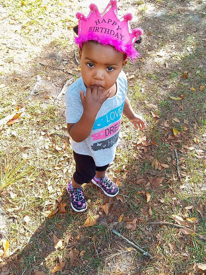 Makenzie joined the competition — help win amazing prizes! baby, baby_toddler_clothing, cap, child, face, fashion_accessory, foot, grass, groundcover, happy, head, magenta, people_in_nature, person, sandal, shorts, soil, t_shirt, thigh, toddler