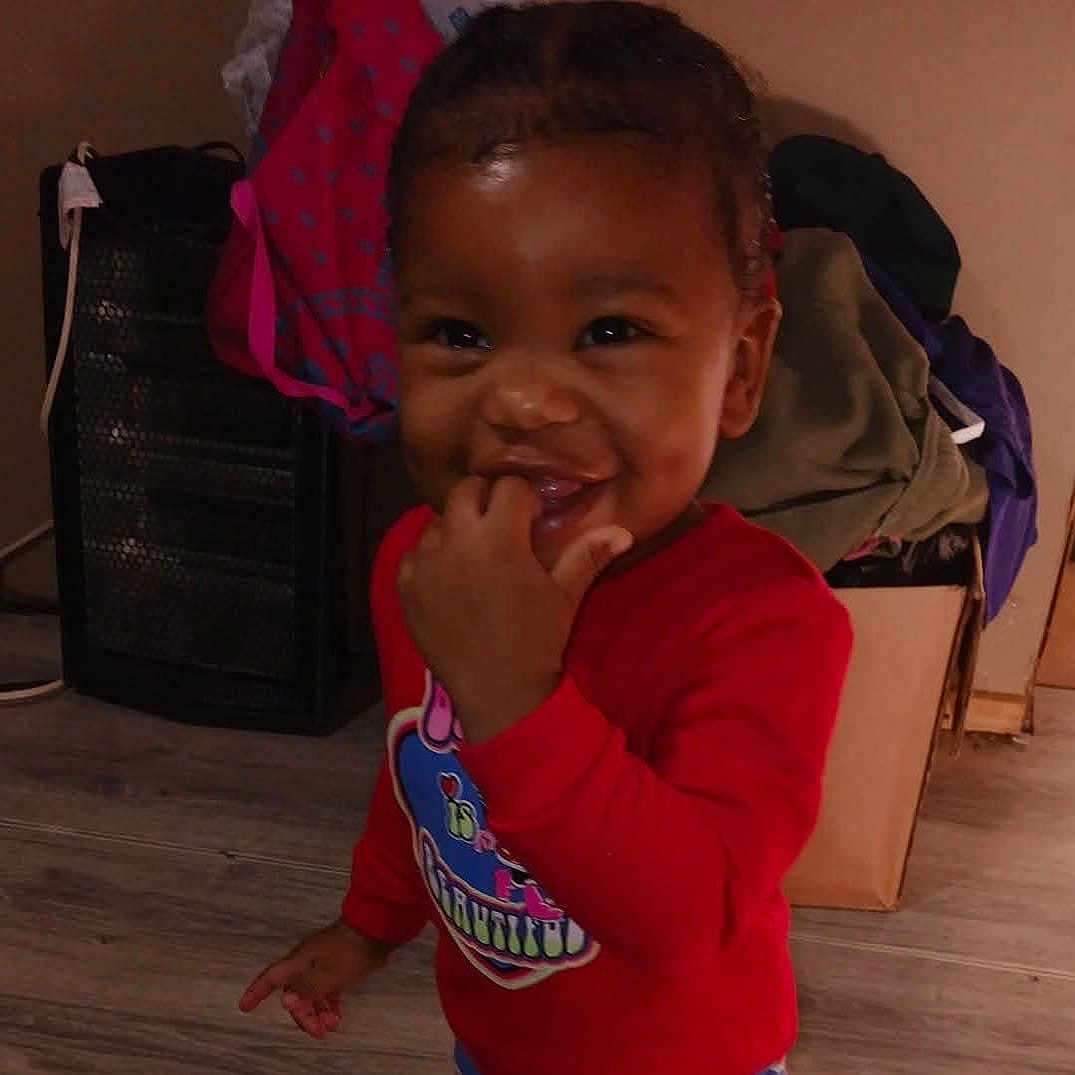 Aubrielle joined the competition — help win amazing prizes! baby, babylaughing, backpack, bag, biting, boy, child, clothing, face, happy, head, male, person, photography, plant, portrait, pottedplant, sitting, smile, t_shirt