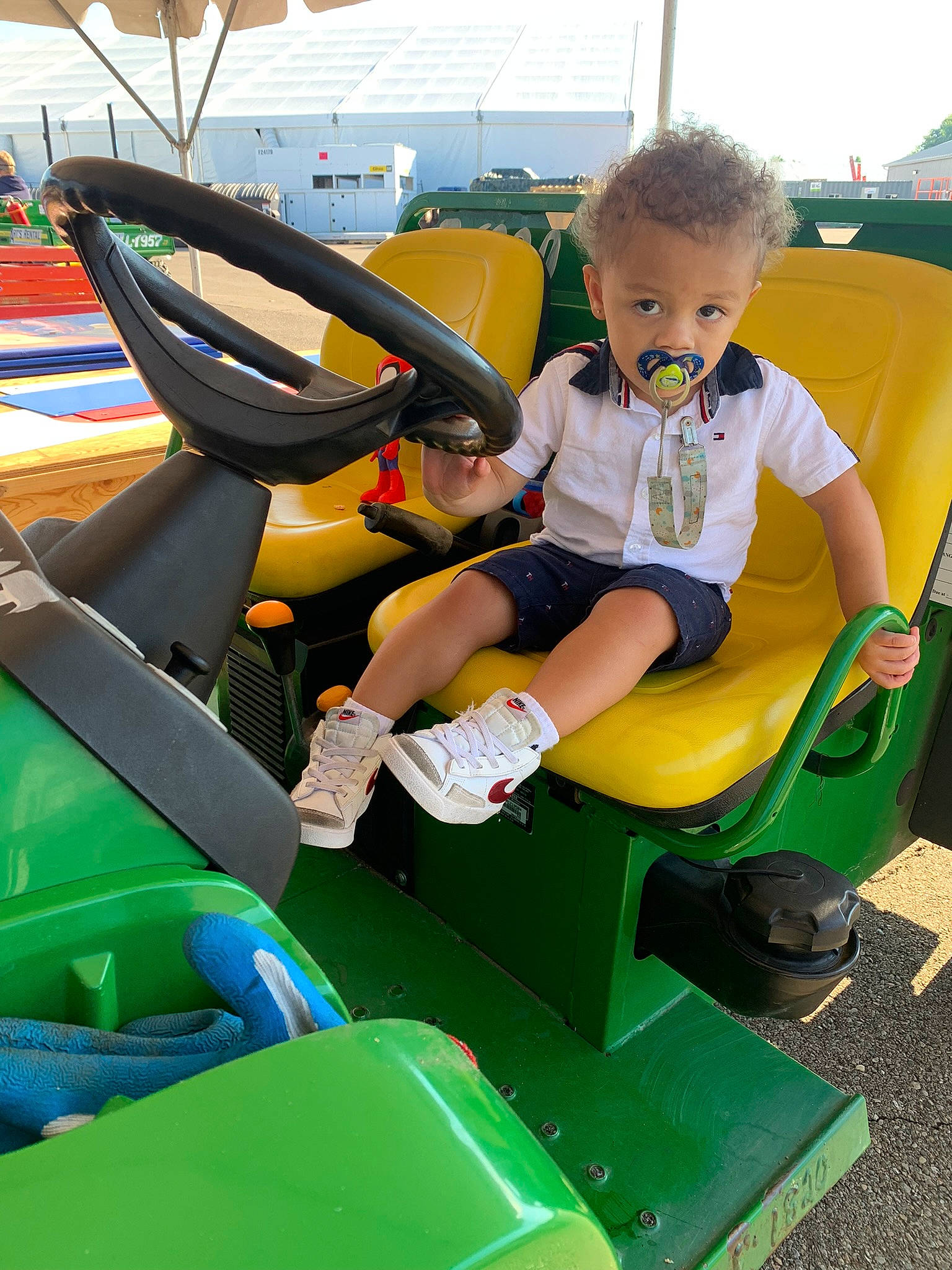 Jaziah is registered to the contest to win money with this photo: automotive_design, automotive_exterior, baby, chute, city, fun, grass, green, lap, leisure, motor_vehicle, person, play, recreation, shoe, shorts, sitting, steering_wheel, t_shirt, toddler