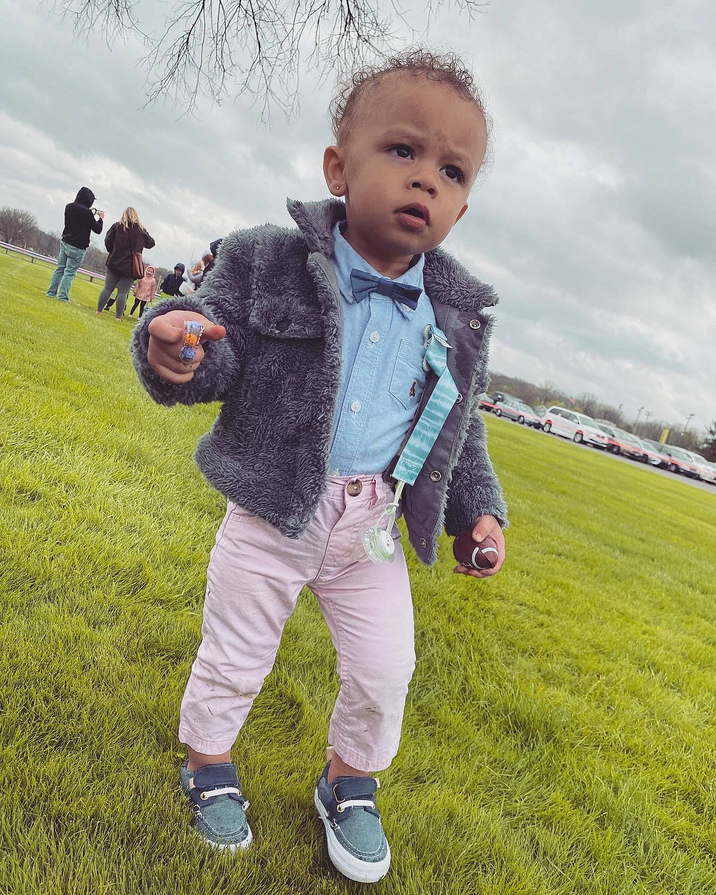 Jaziah is registered to the contest to win money with this photo: ball, child, cloud, football, fun, gesture, grass, grassland, happy, jacket, leisure, people_in_nature, person, plant, player, recreation, sky, sneakers, toddler, toy
