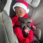 Paris joined the competition — help win amazing prizes! baby, infant, car_seat, red_clothing, santa_hat, sleeping, child, seatbelt, holiday, cute, fuzzy, indoors, person, car_interior, christmas, festive, young_child, baby_clothes, seat, safety