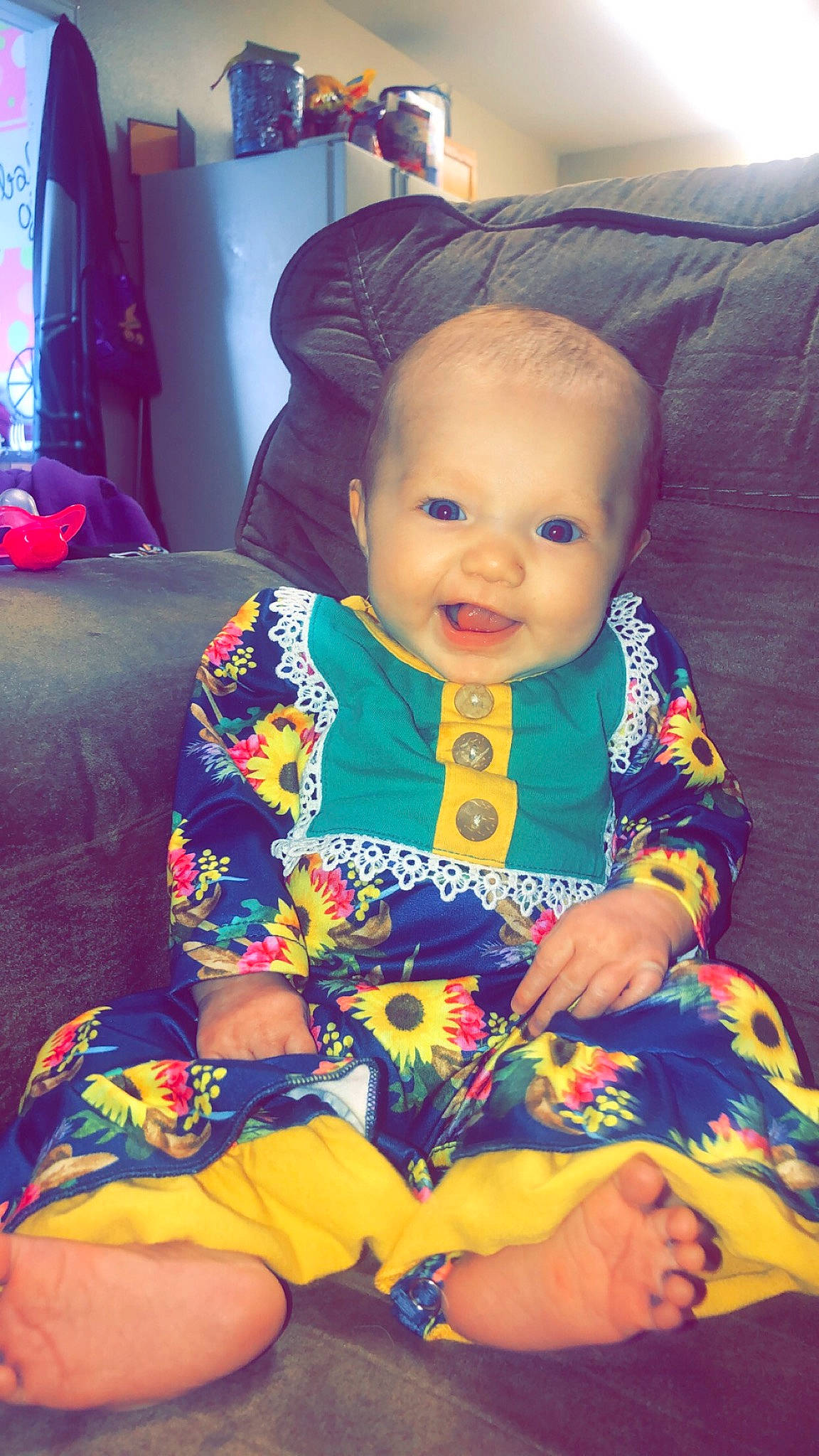 Kensleigh is registered to the contest to win money with this photo: baby, baby_toddler_clothing, cheek, child, comfort, doll, dress, eye, fun, happy, iris, orange, person, purple, sitting, skin, sleeve, smile, textile, toddler