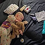 Loralie is registered to the contest to win money with this photo: baby, infant, sleeping, stuffed_bunny, diaper, diaper_stack, baby_wipes, wipes, feeding_bottle, bottles, pacifier, onesie, milestone_sticker, blanket, bed, black_bedspread, syringe, medicine_bottles, soft_toy, newborn