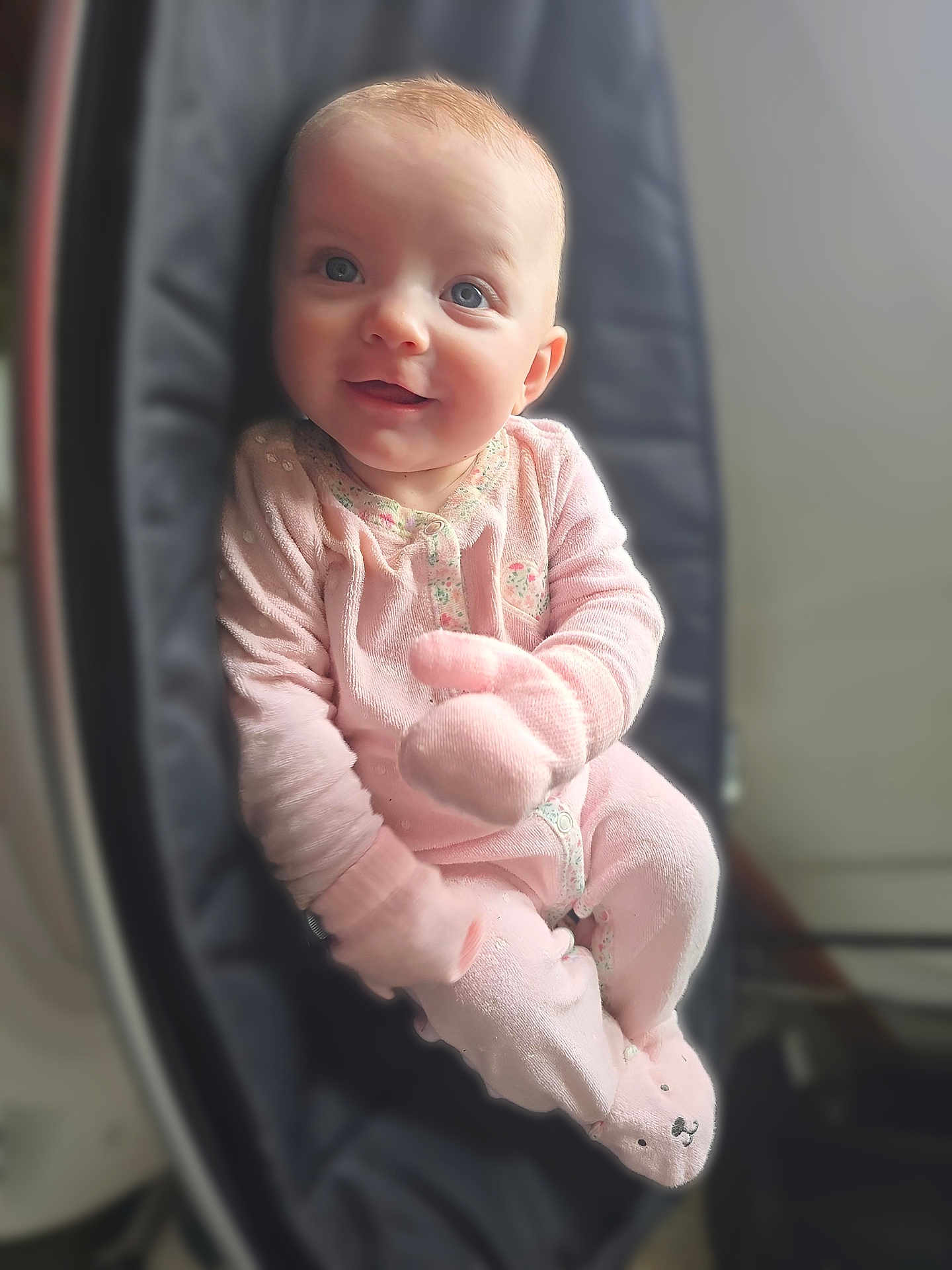 Loralie is registered to the contest to win money with this photo: baby, infant, child, smiling, pink_onesie, mittens, bouncer_seat, face, blue_eyes, cute, portrait, soft_lighting, indoor, cozy, newborn, sitting, footed_pajamas, cheerful, fuzzy_texture, closeup