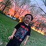 child, boy, sunset, park, grass, trees, smile, tshirt, black_clothing, spiderman, superhero, outdoor, nature, young, happy, casual, footwear, daylight, portrait, person