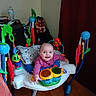Kae-Lynn is registered to the contest to win money with this photo: baby, child, smile, indoor, toys, jumper, colorful, floor, wooden_floor, curtain, furniture, pillow, play, happy, person, infant, face, clothing, room, baby_toys