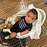 Zakkai joined the competition — help win amazing prizes! baby, shopping_cart, blanket, mittens, onesie, infant, floor, face, curious, person, clothing, footwear, indoor, baby_seat, retail, store, cute, child, head, expression