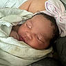 Kaliyah is registered to the contest to win money with this photo: baby, newborn, sleeping, blanket, headband, pink, striped, hand, face, skin, closeup, indoors, peaceful, resting, cute, child, person, soft, wrapped, cozy
