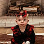 baby, child, plaid, dress, headband, bow, fireplace, firewood, rug, floor, indoors, person, cute, sitting, portrait, blue_eyes, clothing, infant, home, cozy