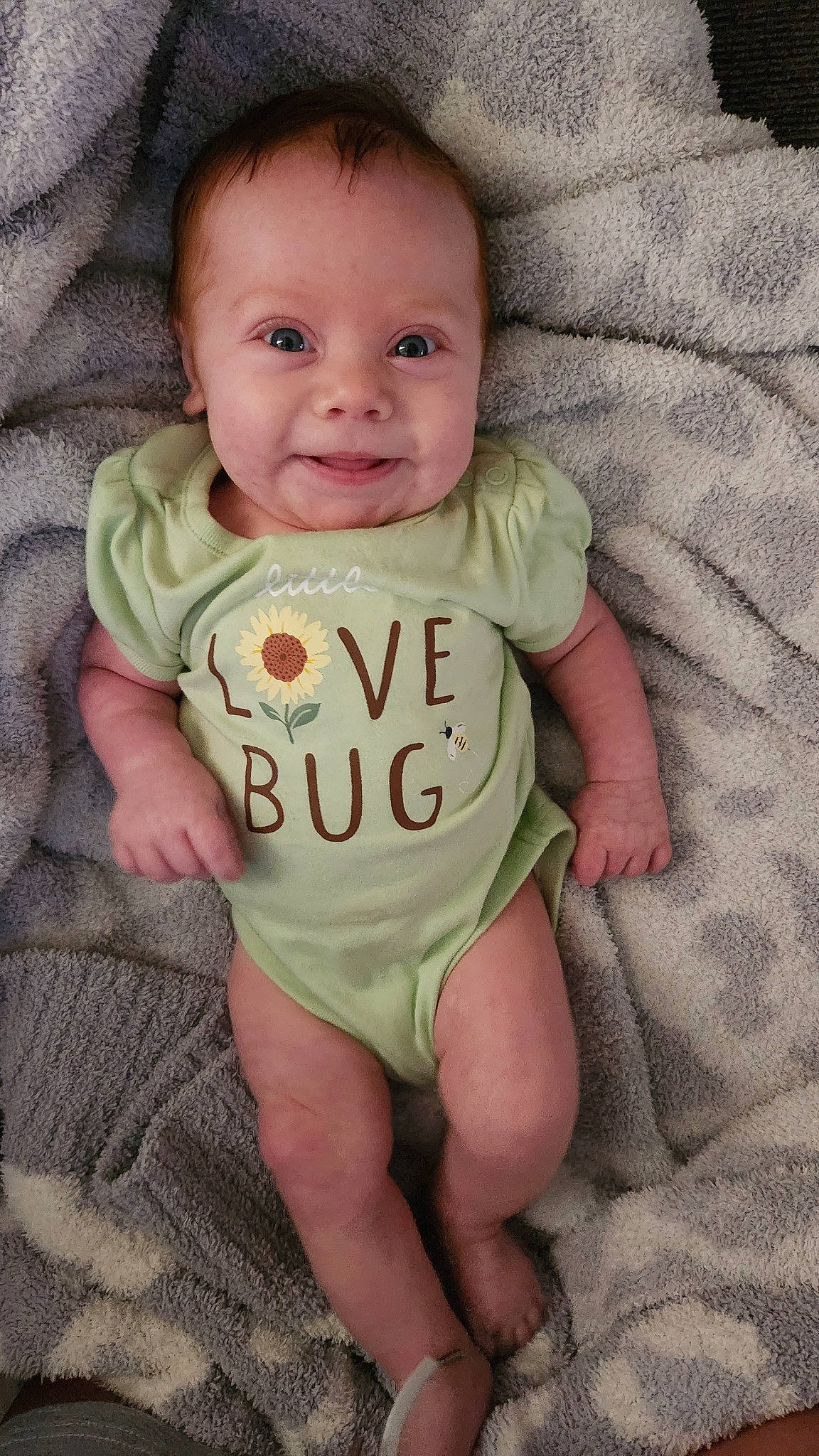 Peyten is registered to the contest to win money with this photo: arm, baby, baby_toddler_clothing, cheek, comfort, face, finger, hand, happy, infant_bodysuit, iris, mouth, neck, nose, person, skin, sleeve, smile, t_shirt, thumb