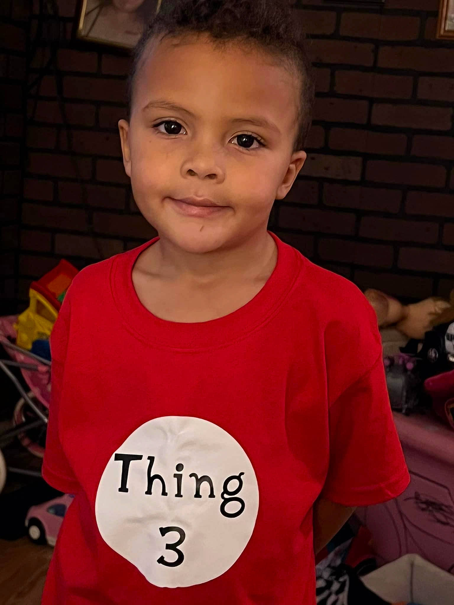 Demari joined the competition — help win amazing prizes! baby_toddler_clothing, chair, cheek, child, cool, eye, face, forehead, fun, hairstyle, happy, head, joy, neck, person, red, skin, sleeve, smile, standing