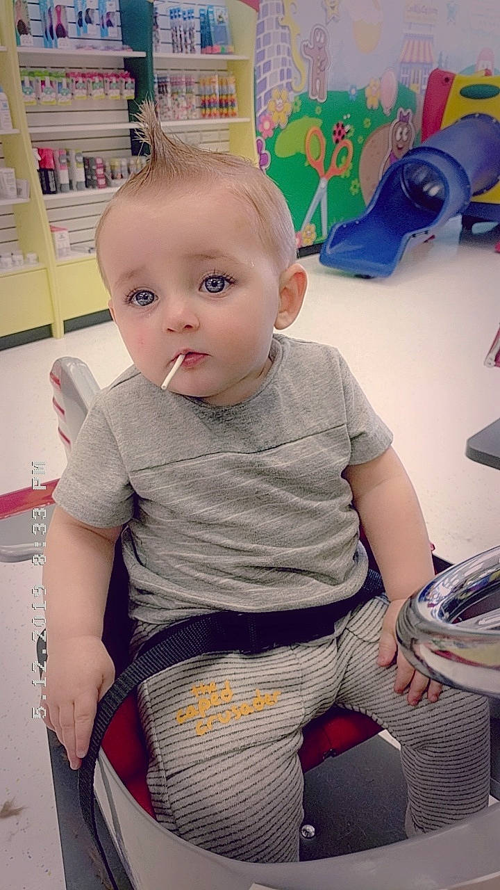 Remington is registered to the contest to win money with this photo: baby, cheek, child, ear, forehead, head, leg, person, sitting, skin, smile, standing, t_shirt, toddler