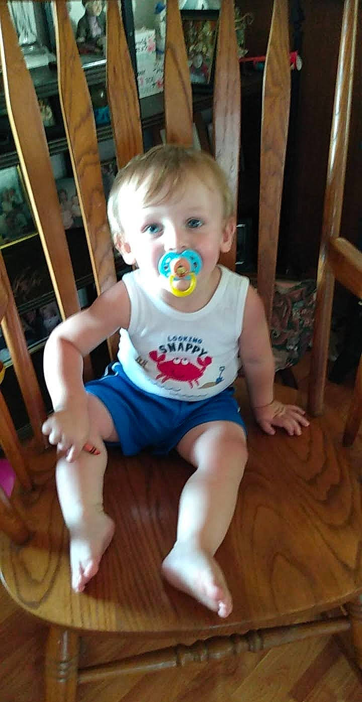 Jayden is registered to the contest to win money with this photo: baby, baby_toddler_clothing, barefoot, chair, cheek, child, face, flooring, foot, fun, happy, hardwood, head, person, sitting, sleeve, smile, t_shirt, toddler, wood