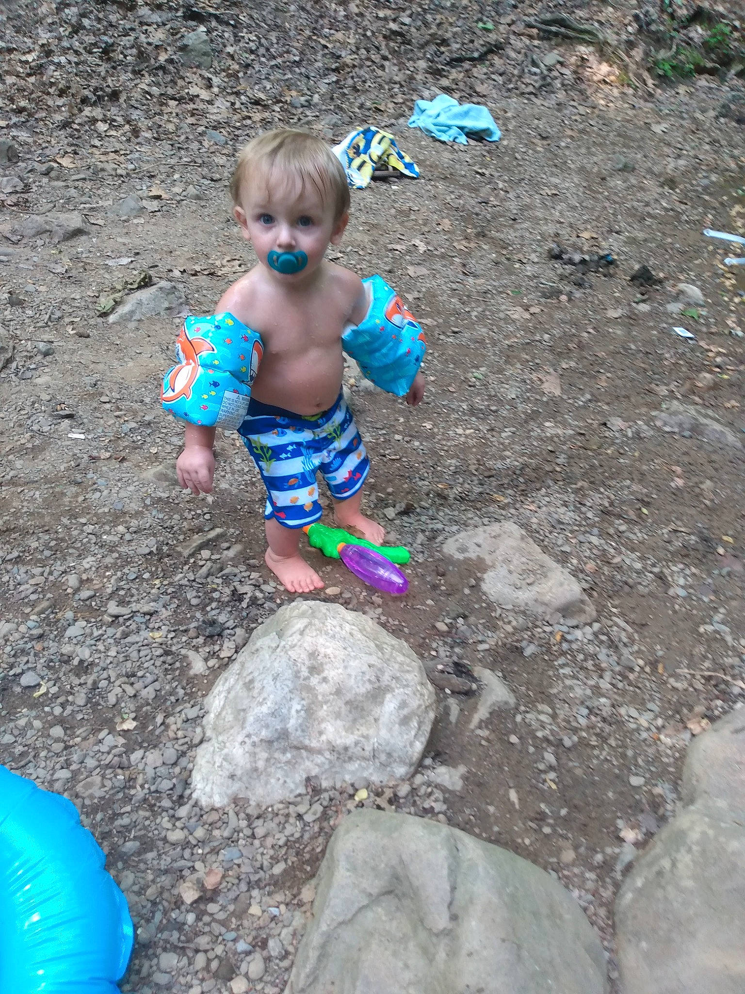 Jayden is registered to the contest to win money with this photo: ball, balloon, blue, body_of_water, child, concrete, electric_blue, fun, grass, head, leisure, person, play, recreation, rock, sand, sitting, soil, surprise, t_shirt