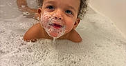 Harmony is registered to the contest to win money with this photo: toddler, child, bath, bathtub, bubbles, foam, water, curly_hair, face, skin, blue_eyes, soap, playing, happy, wet, indoor, cleaning, fun, cute, baby