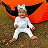 baby, child, infant, halloween, pumpkin, inflatable, grass, outdoor, costume, white_clothing, headband, smile, cute, fall, leaves, festive, holiday, seasonal, fun, portrait
