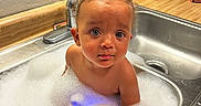 Harmony joined the competition — help win amazing prizes! toddler, child, bath, bubble_bath, sink, kitchen, foam, curly_hair, wet_skin, countertop, pineapple, soap, water, playful, indoor, portrait, cute, expression, small_person, bathing