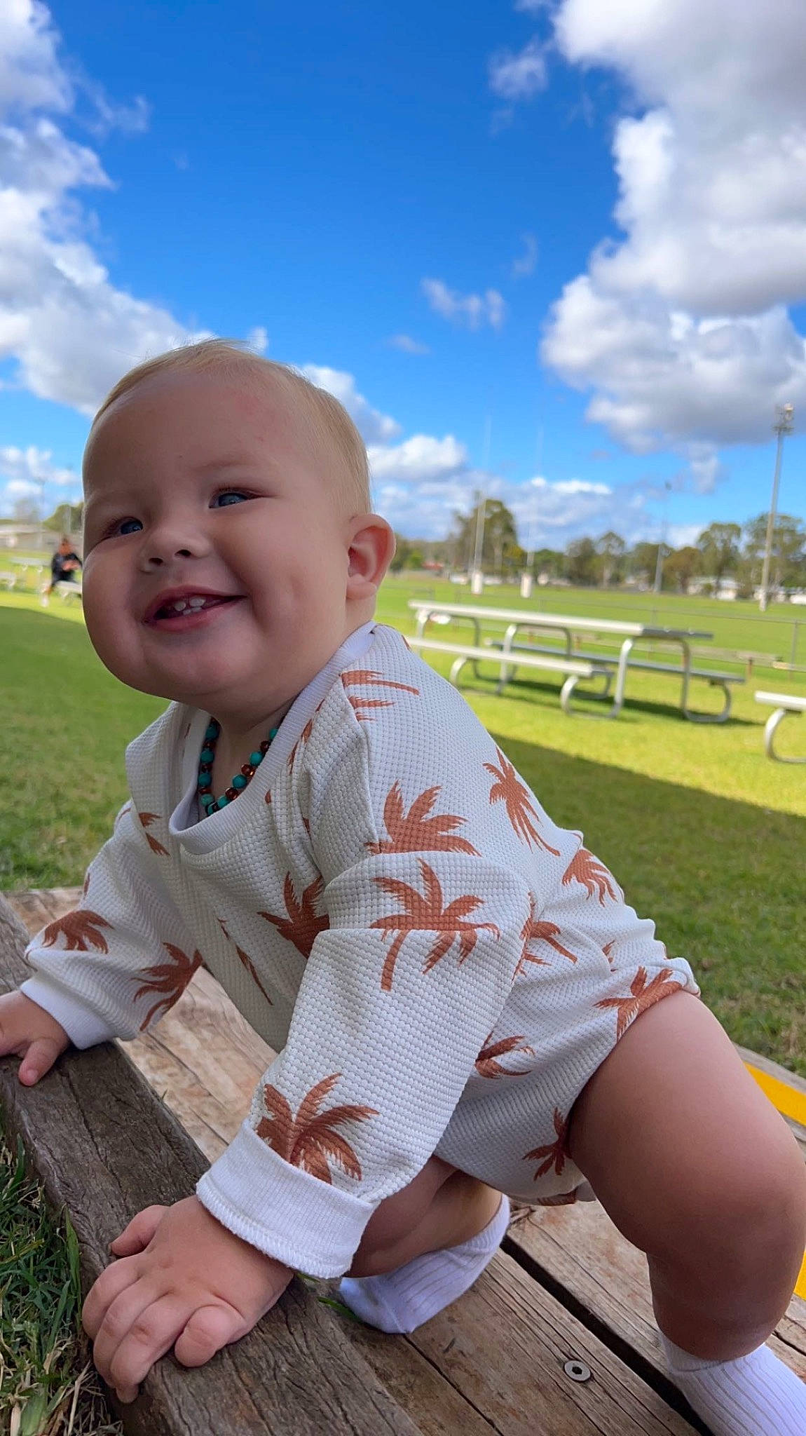 Colby is registered to the contest to win money with this photo: baby, baby_toddler_clothing, cloud, face, fun, grass, happy, joy, lawn, leisure, meadow, people_in_nature, person, plant, recreation, skin, sky, sleeve, smile, thigh