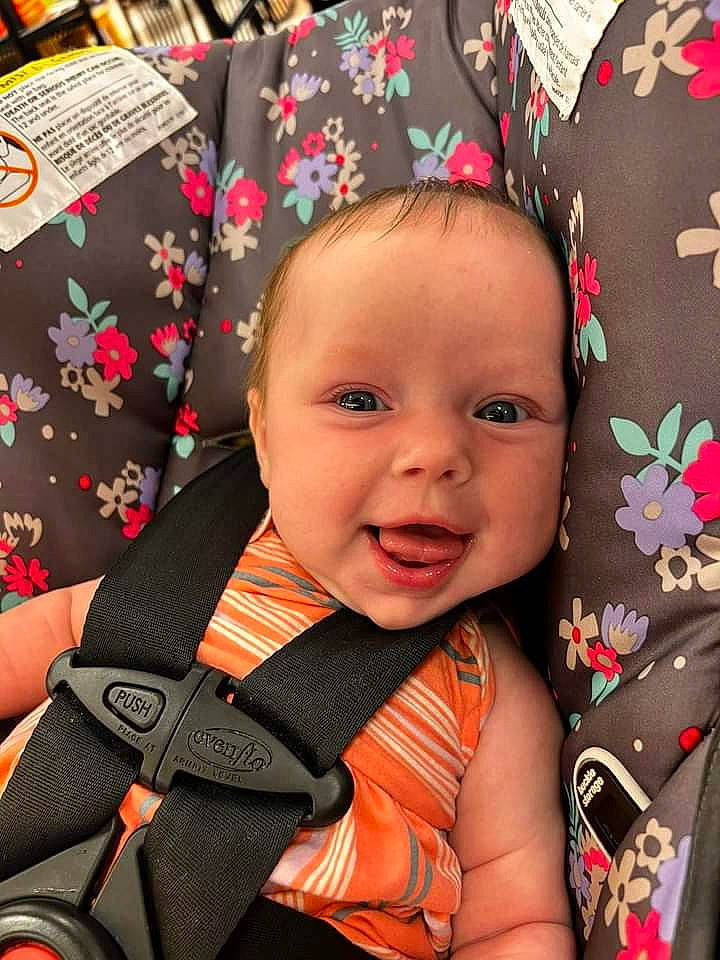 Caroline joined the competition — help win amazing prizes! baby, baby_carriage, baby_products, baby_toddler_clothing, car_seat, cheek, child, comfort, event, facial_expression, fashion_accessory, happy, head, iris, linens, orange, pattern, person, sitting, smile