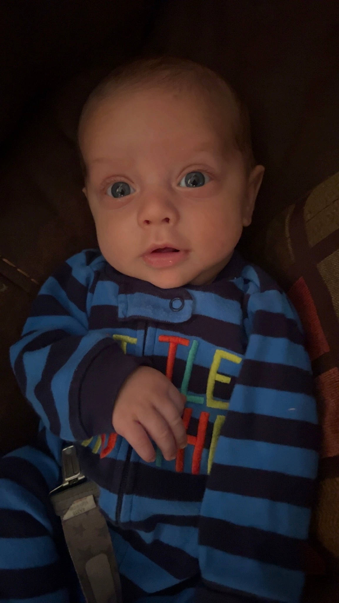 Noah is registered to the contest to win money with this photo: baby, baby_products, baby_toddler_clothing, cheek, child, comfort, electric_blue, eyebrow, forehead, human_body, iris, lip, mouth, nose, outerwear, person, sitting, sleeve, smile, t_shirt