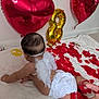 baby, infant, diaper, angel_wings, heart_balloon, gold_balloon, red_petals, blanket, crawling, headband, back_of_head, skin, party_decor, indoor, white_wall, soft_texture, celebration, ribbon, floor, photography