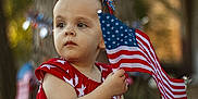 Savannah joined the competition — help win amazing prizes! toddler, child, flag, american_flag, red_dress, headband, patriotic, outdoor, grass, holiday, celebration, summer, festive, stars, stripes, young_child, sitting, holding, costume, cute