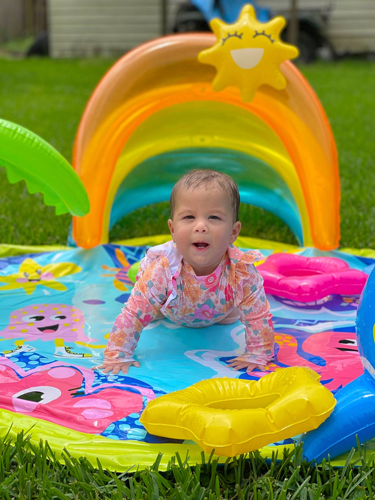 Cheyenne Rae is registered to the contest to win money with this photo: baby_toddler_clothing, child, facial_expression, fun, grass, green, happy, leaf, leisure, light, nature, people_in_nature, person, photograph, plant, product, public_space, rainbow, smile, toddler